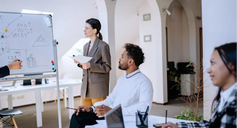 image of a woman presenting to a man and a women